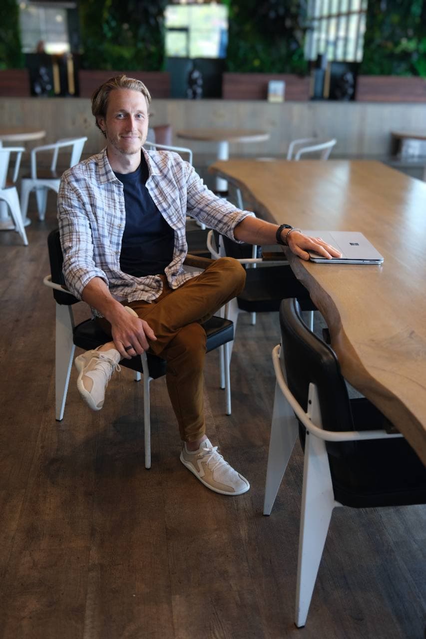 Davey Edwards seated at a table with his laptop